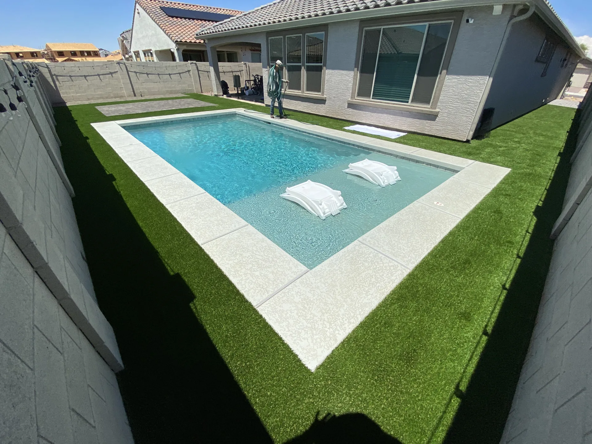 Pool surrounded by turf