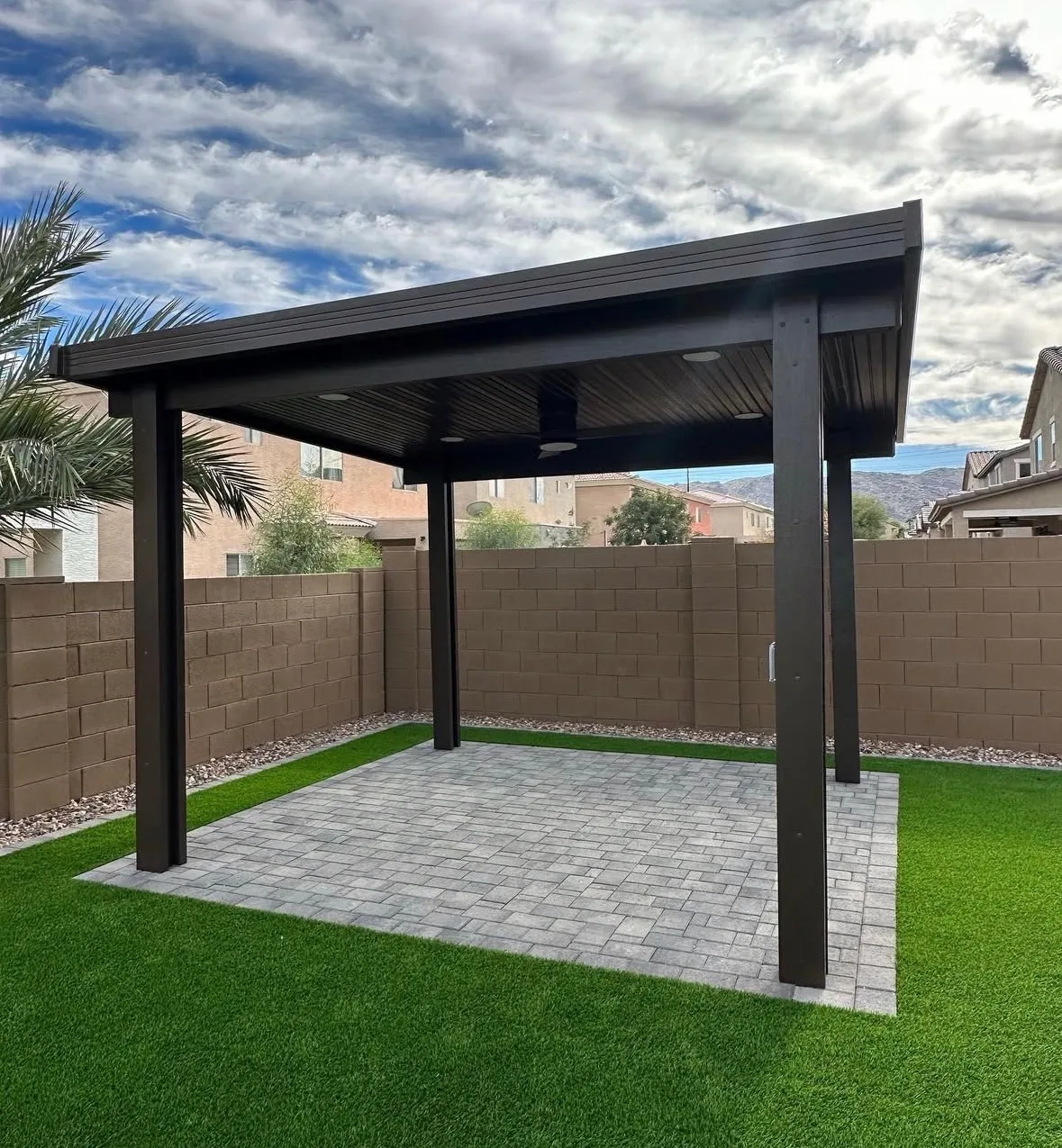 Pergola with ceiling fan under cloudy sky